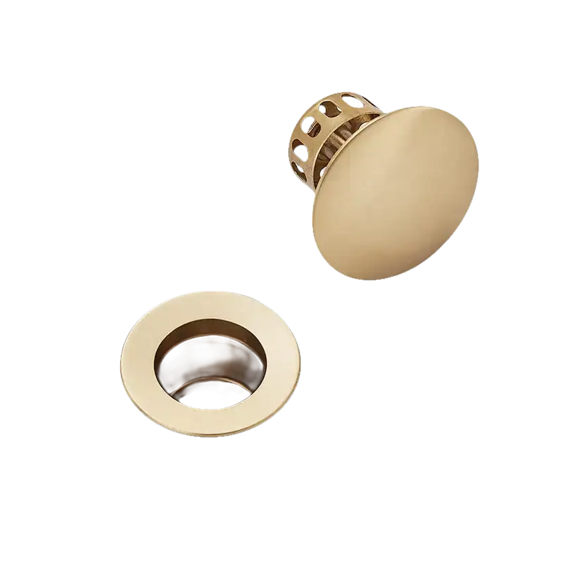 Gold-colored sink drain and stopper.
