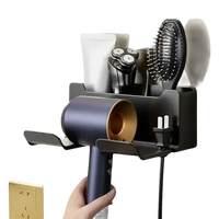 Wall-mounted hair dryer and accessory organizer.