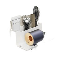 Wall-mounted hair dryer and accessory organizer.