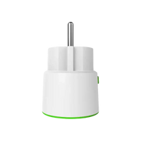 White smart plug with green trim.