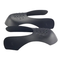 Black shoe trees with ventilation holes.