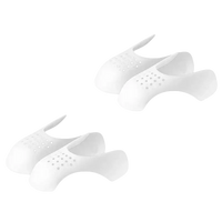 Two pairs of white, perforated shoe inserts.