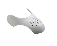 White shoe shield with ventilation holes.