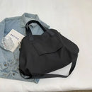 Black tote bag with shoulder strap.