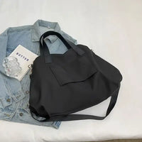 Black tote bag with shoulder strap.