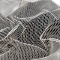 Crumpled white hexagonal mesh fabric.