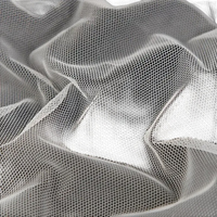 Wrinkled white hexagonal mesh fabric.