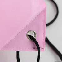 Pink drawstring bag corner.