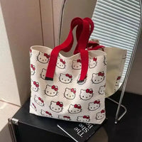 Hello Kitty patterned tote bag with red straps.