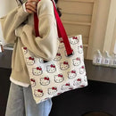 Hello Kitty patterned tote bag with red straps.