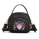 Black crossbody bag with cartoon character.