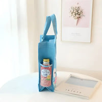 Light blue reusable tote bag with a side pocket containing a beverage.