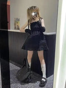 Black textured dress with ruffled hem.