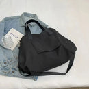 Black tote bag with shoulder strap.
