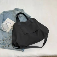Black tote bag with shoulder strap.