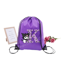 Purple drawstring bag with cartoon character and letter K.
