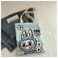 Light blue tote bag with cartoon bunny design.