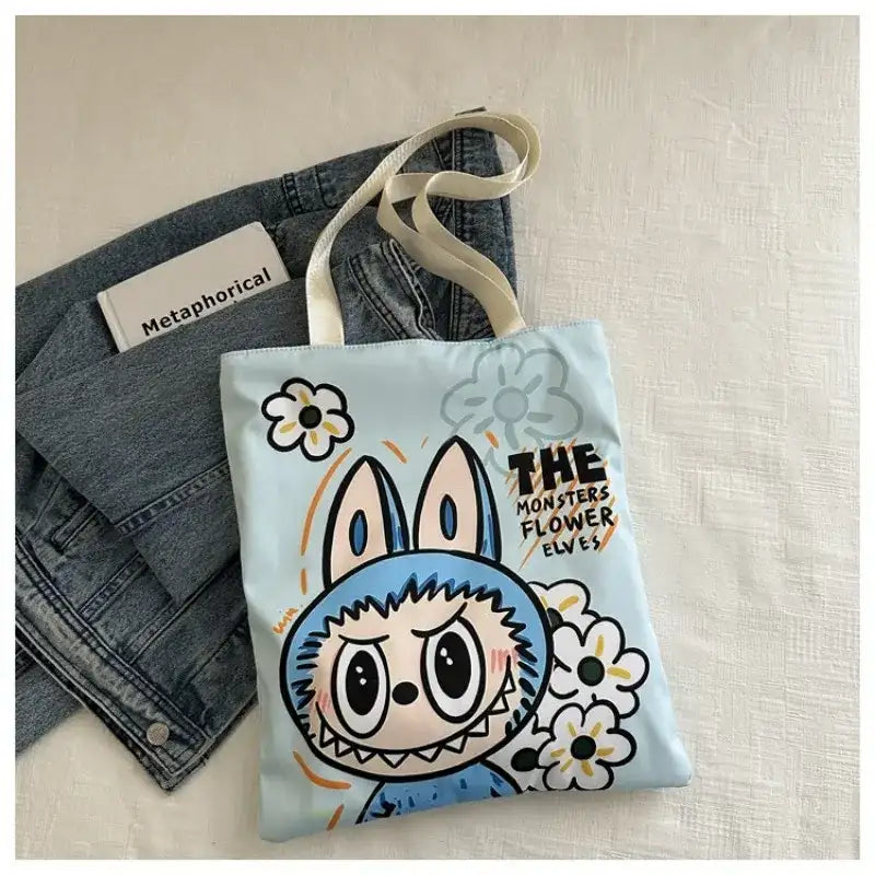 Light blue tote bag with cartoon bunny design.