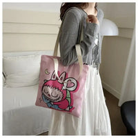 Pink tote bag with cartoon character.