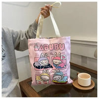 Pink tote bag with cartoon bunny designs.