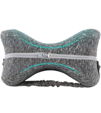 Gray knee pillow with elastic strap.