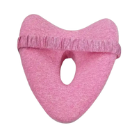 Pink knee pillow with elastic strap.
