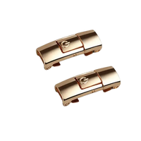 Two gold-colored magnetic press locks.