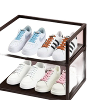 Two-tiered shoe rack with sneakers.