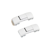Two white magnetic shoelace buckles.
