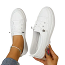 White canvas slip-on sneakers.
