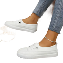 White slip-on sneakers.