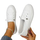 White canvas slip-on sneakers.
