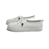 Pair of white lace-up sneakers.