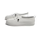 Pair of white lace-up sneakers.
