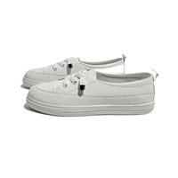 Pair of white lace-up sneakers.