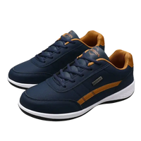 Pair of navy blue and tan sneakers.