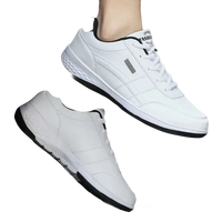 White leather sneakers with black trim.