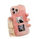 Pink phone case with anime stickers.