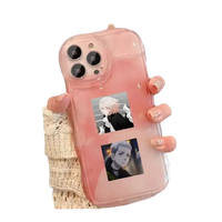 Pink phone case with anime stickers.