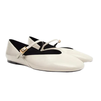Pair of white patent leather Mary Jane flats.