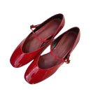 Pair of red patent leather Mary Jane shoes.
