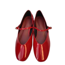 Pair of red patent leather Mary Jane shoes.