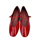 Pair of shiny red Mary Jane shoes.