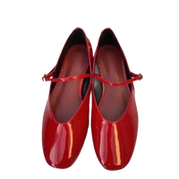 Pair of shiny red Mary Jane shoes.