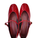 Pair of shiny red Mary Jane shoes.