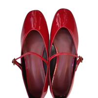 Pair of shiny red Mary Jane shoes.