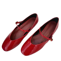 Pair of shiny red Mary Jane shoes.