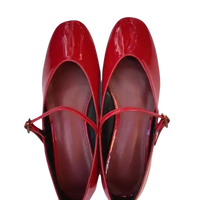 Pair of shiny red Mary Jane shoes.