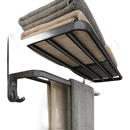 Black metal towel rack with folded towels.