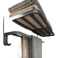 Black metal towel rack with folded towels.